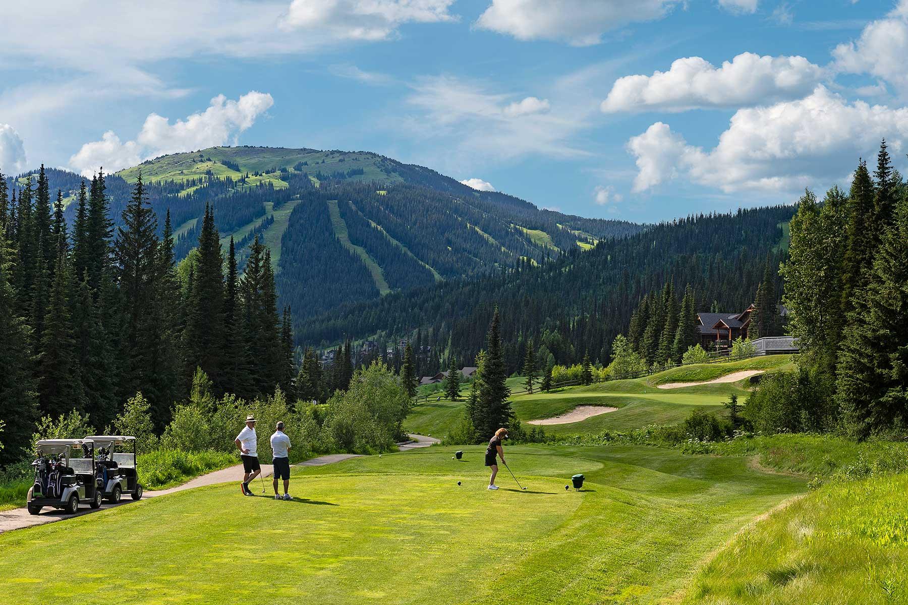 Golfer's teeing off on hole 15 at Sun Peaks Golf Course