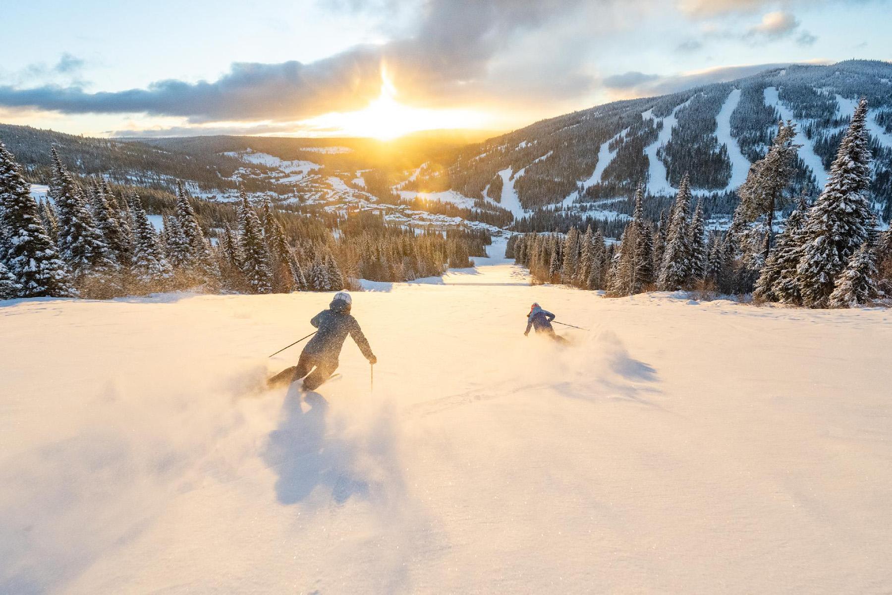 Skiers, skiing down Exhibition at Sun Peaks Resort BC